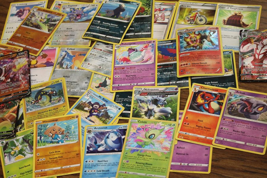 An assortment of trading cards, mostly pokemon cards.